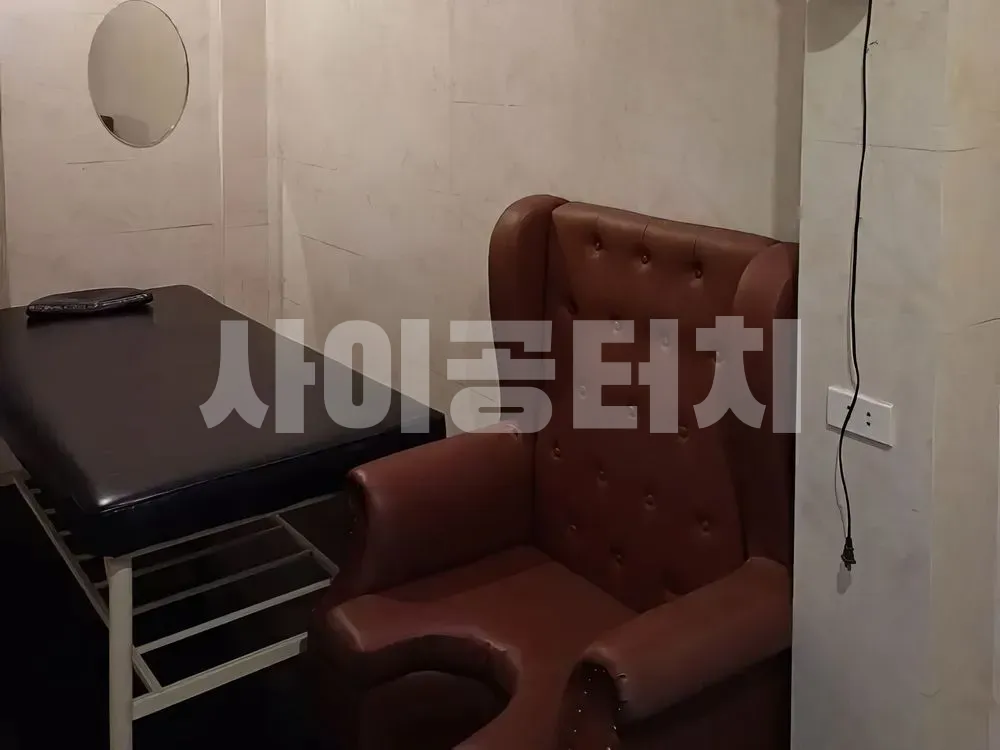 마사지 베드와 갈색 가죽 의자가 있는 방